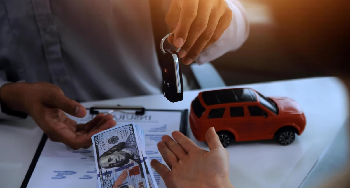 vecteezy-young-man-receives-a-key-from-car-salesman-after-agreeing-to-a-contract-for-rent-or-sale-of-a-car-at-workshop-loan-car-insurance-sale-buying-car-and-finance-concept-free-photo